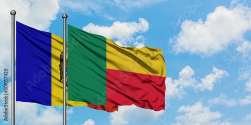 Moldova and Benin flag waving in the wind against white cloudy blue sky together. Diplomacy concept, international relations.