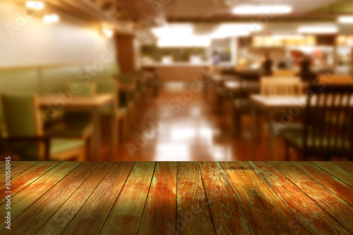 Top desk with blur restaurant background,wooden table
