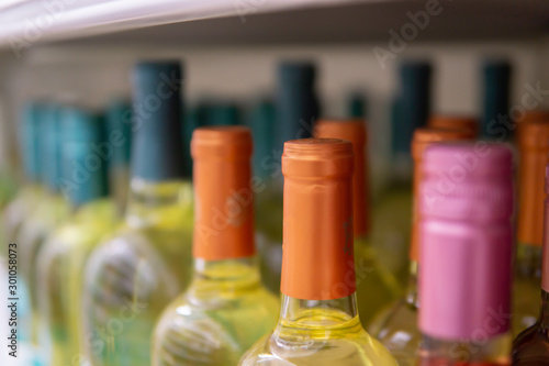 Wine bottles kept cold in a fridge