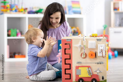 Child with teacher playing ...