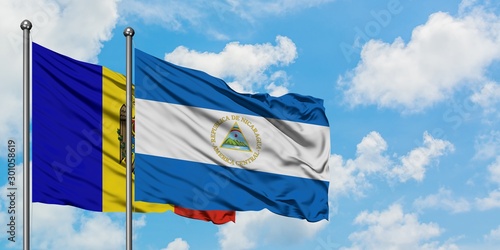 Moldova and Nicaragua flag waving in the wind against white cloudy blue sky together. Diplomacy concept, international relations.