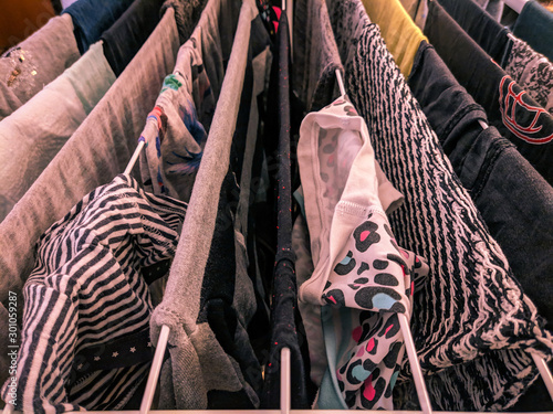 Washed clothing hanging on laundry drying rack. © Said