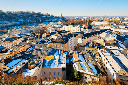 Panorama of Salzburg with snow from Kapuzinerberg hill in Austria. Landscape and cityscape of Mozart city in Europe at winter. Panoramic view of old Austrian town of Salzburgerland. Landmark