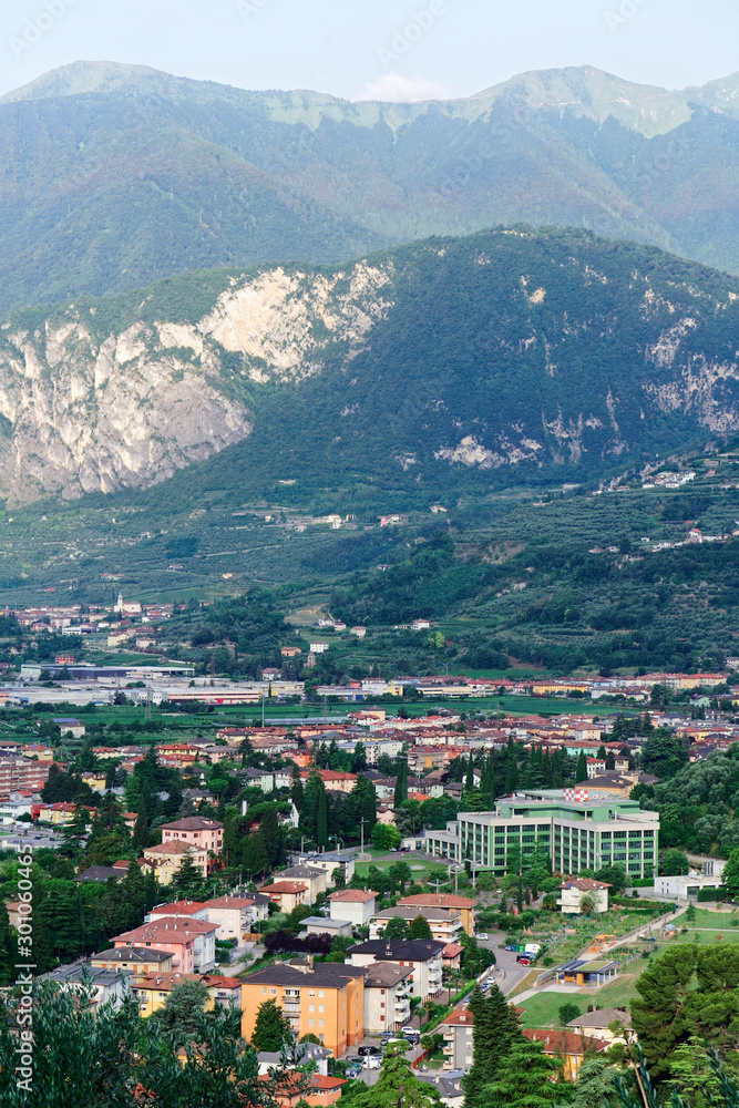 Aerial view with Landscape of Arco town at rock at Sarca Valley near Garda lake of Trentino in Italy. Scenery with cityscape and mountain at Arco old city in Trento near Riva del Garda. Outdoor