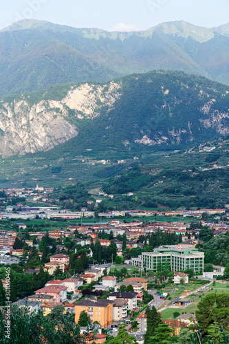 Aerial view with Landscape of Arco town at rock at Sarca Valley near Garda lake of Trentino in Italy. Scenery with cityscape and mountain at Arco old city in Trento near Riva del Garda. Outdoor © Roman Babakin