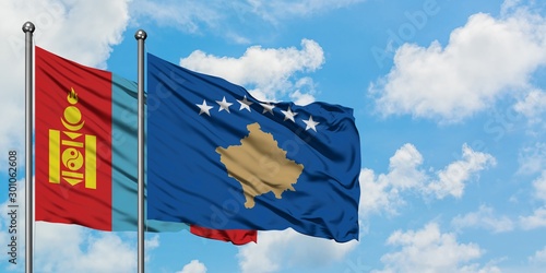 Mongolia and Kosovo flag waving in the wind against white cloudy blue sky together. Diplomacy concept, international relations.