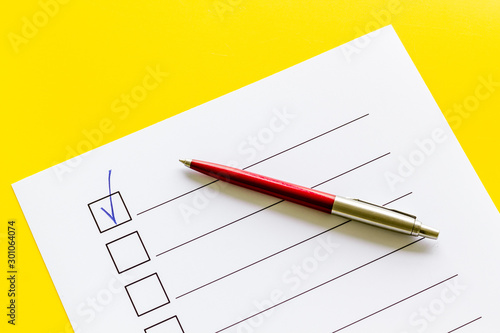 Empty check list ready to fill on yellow background top view