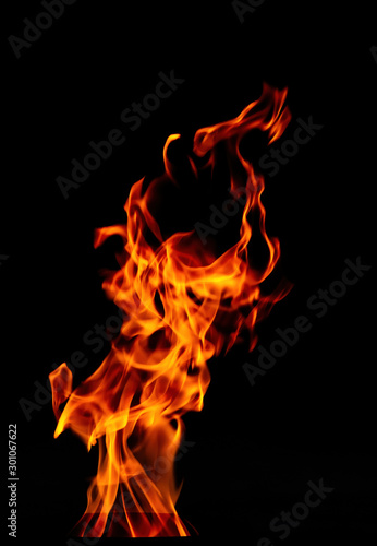 Fire flame isolated on black background. Beautiful dance of fire.