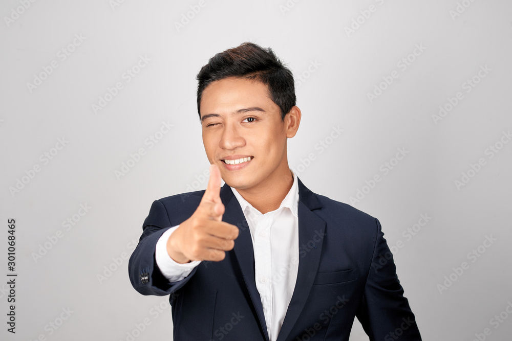 Young man employer dressed in business costume pointing finger on copyspace Young man employer dressed in business costume pointing finger on copyspace