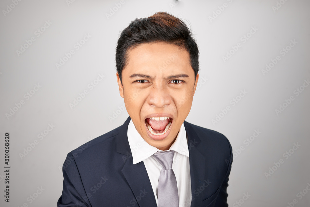 Angry businessman shouting isolated in a white background Angry businessman shouting isolated in a white background