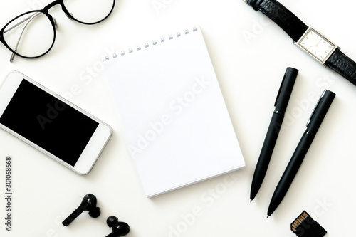White office desk table blank and supplies. Copy space. Flat lay.