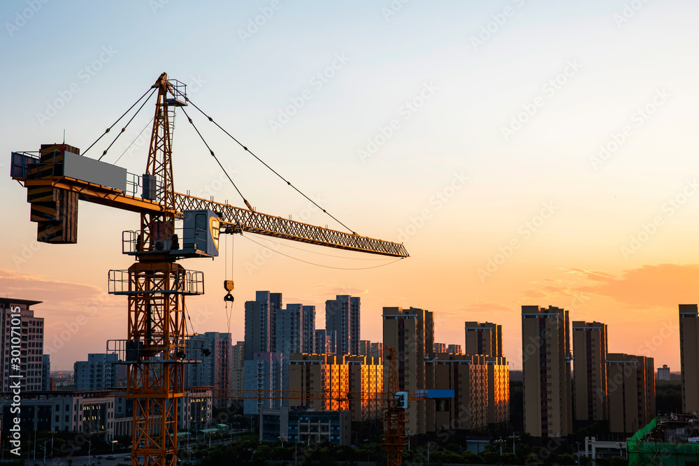 Tower cranes build residential buildings at nigh
