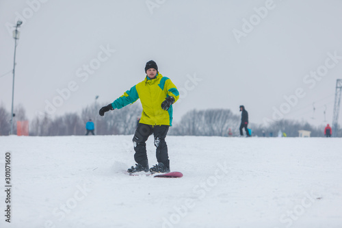 man snowboarding down by hill