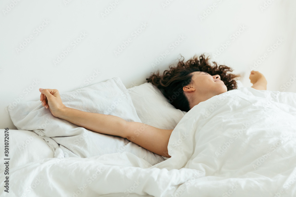 young pretty woman in bed with white sheets bright light young pretty woman in bed with white sheets bright light