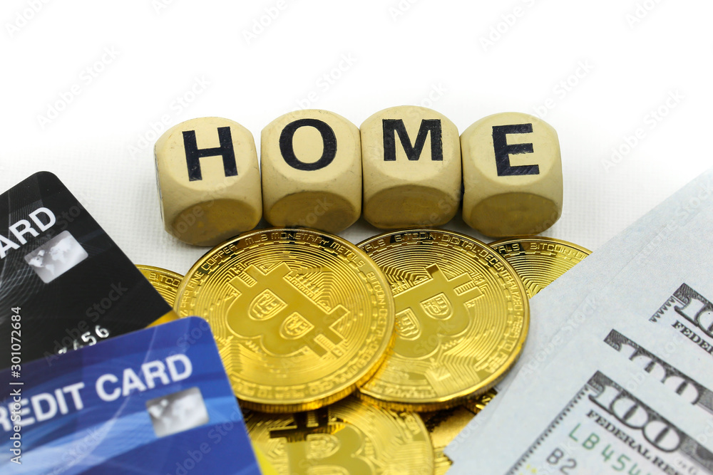 Home wooden blocks of money with dollars,bitcoins,credit card background,Saving money for buy house concept. Home wooden blocks of money with dollars,bitcoins,credit card background,Saving money for buy house concept.