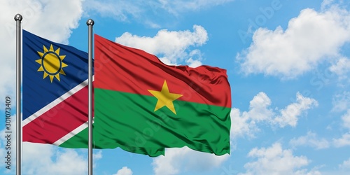 Namibia and Burkina Faso flag waving in the wind against white cloudy blue sky together. Diplomacy concept  international relations.