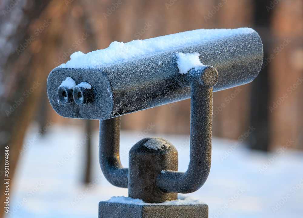 Binoculars in the park in winter at dawn Binoculars in the park in winter at dawn