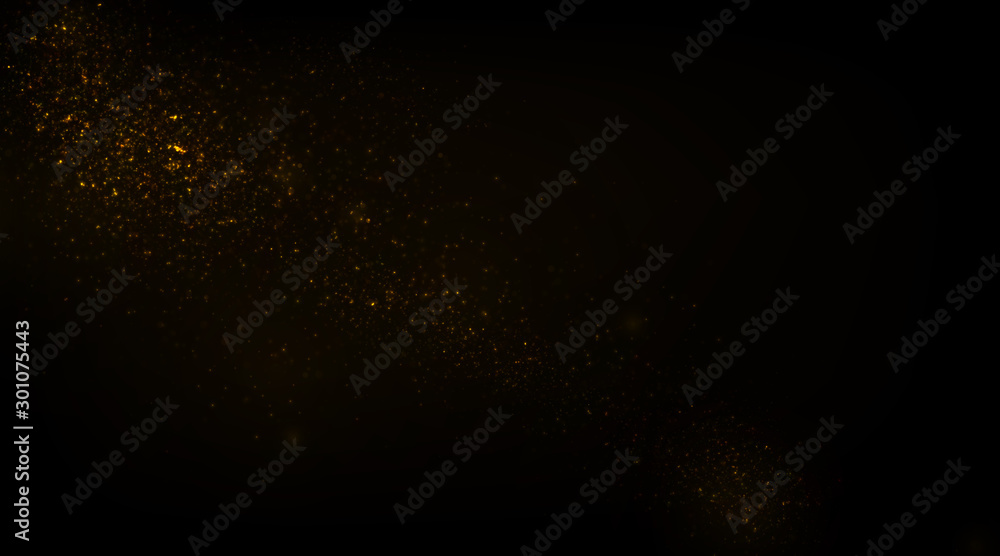 Glowing golden particles on black background	