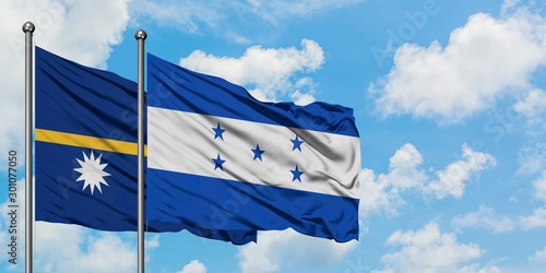 Nauru and Honduras flag waving in the wind against white cloudy blue sky together. Diplomacy concept, international relations.