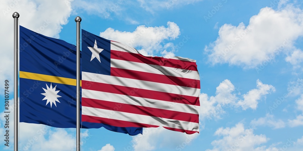 Nauru and Liberia flag waving in the wind against white cloudy blue sky together. Diplomacy concept, international relations. Nauru and Liberia flag waving in the wind against white cloudy blue sky together. Diplomacy concept, international relations.