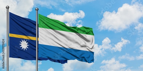 Nauru and Sierra Leone flag waving in the wind against white cloudy blue sky together. Diplomacy concept, international relations.