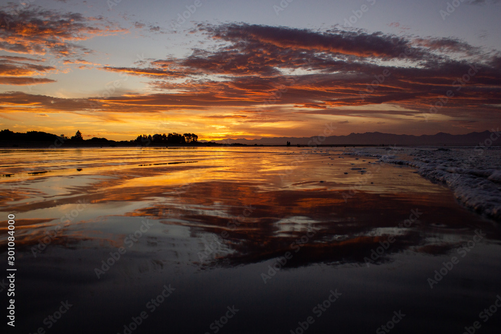 beach in nelson during a breathtaking sunset on Tahunanui Beach at Nelson, New Zealand