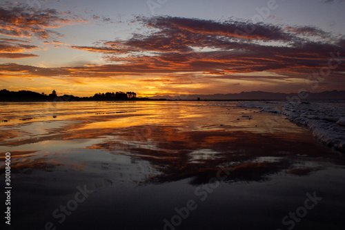 beach in nelson during a breathtaking sunset on Tahunanui Beach at Nelson  New Zealand