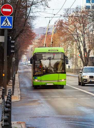 Green trolleybus on city street