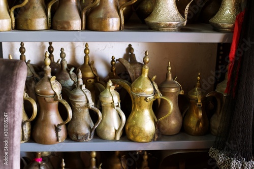 antique brass coffee pots ( Dallah) used to serve Arabic coffee , Traditional uae and saudi brass coffee pot, united Arab emirates traditional coffee , antique store 