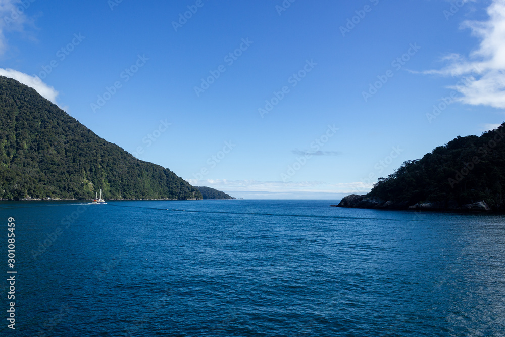 Milford Sound on a ferry on a beautiful blue sky day, Fiordland, South Island,New Zealand.
