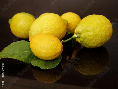 ripe yellow lemons on dark background