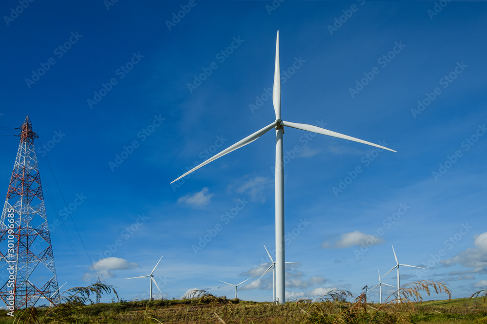 Wind turbines generating electricity with blue sky background,from wind power for environmental,Clean energy Wind turbines generating electricity with blue sky background,from wind power for environmental,Clean energy