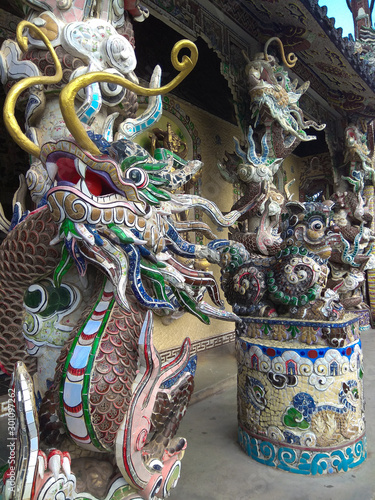 Dragon decorated whith broken glass in frony of a Buddhist temple photo