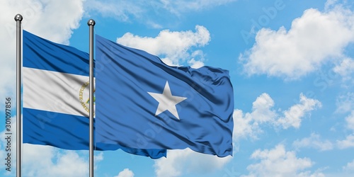 Nicaragua and Somalia flag waving in the wind against white cloudy blue sky together. Diplomacy concept, international relations.