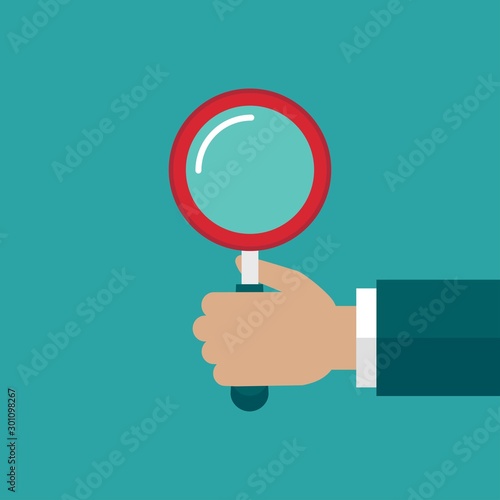 hand with red magnifier isolated on blue. Magnifying glass.