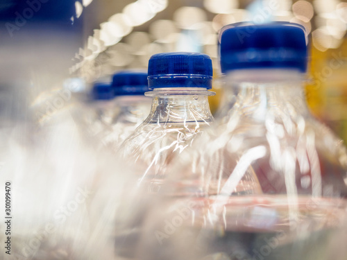 Transparent plastic bottles with a carbonated drink on the conveyor