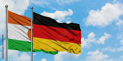 Niger and Germany flag waving in the wind against white cloudy blue sky together. Diplomacy concept  international relations.