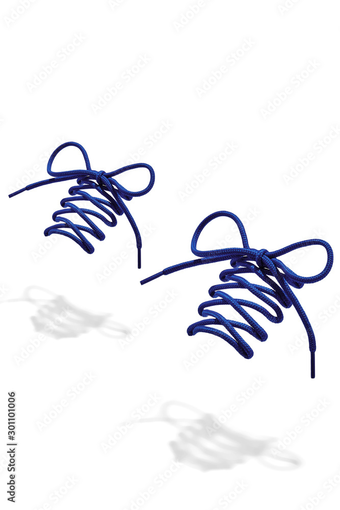 Φωτογραφία The photo of blue wicker round shoelaces with blue tips, hanging in the air on a white background