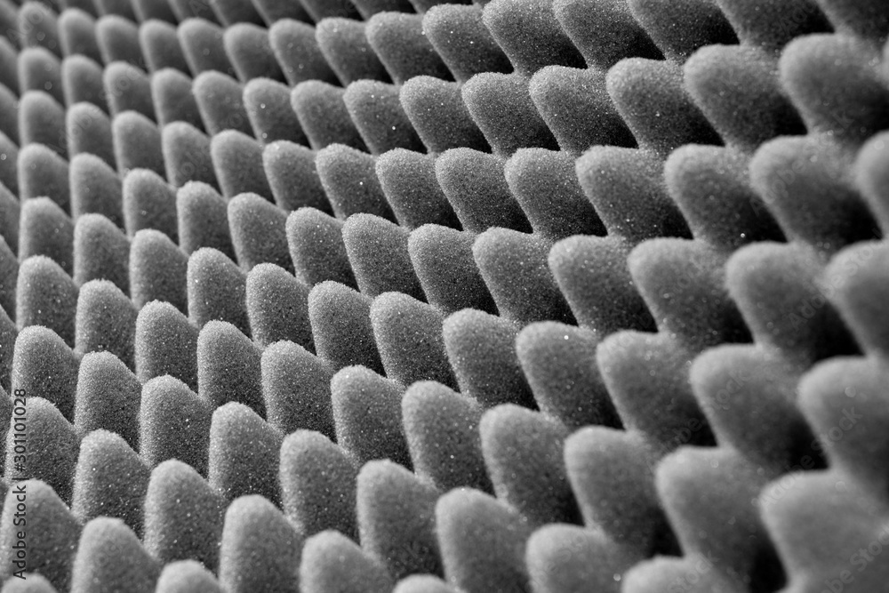 Fotografie Dark artificial foam, acoustic foam insulation texture on background