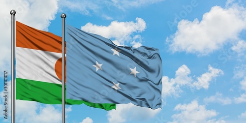 Niger and Micronesia flag waving in the wind against white cloudy blue sky together. Diplomacy concept  international relations.