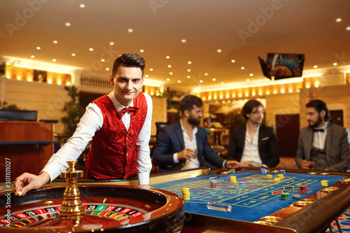A croupier works at a poker roulette in a casino.