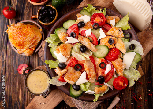 Vegetable and meat salad of mozzarella, cheese, olives, chicken, cucumber, tomatoes. Low carb dietary food.