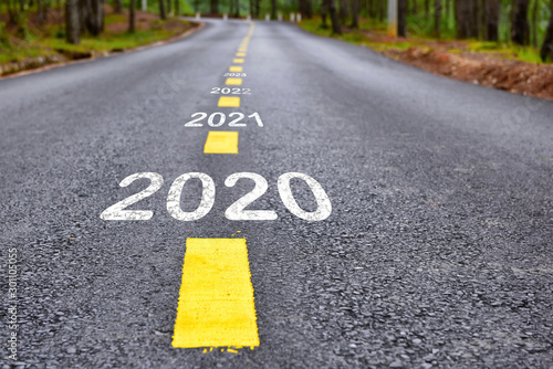 Number of 2020 to 2023 on asphalt road surface with marking lines, happy new year concept