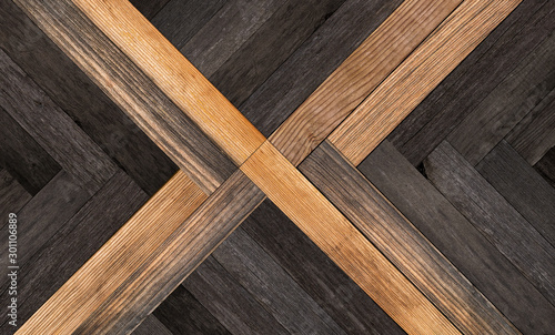 Wood texture for background. Old dark parquet floor with abstract pattern.