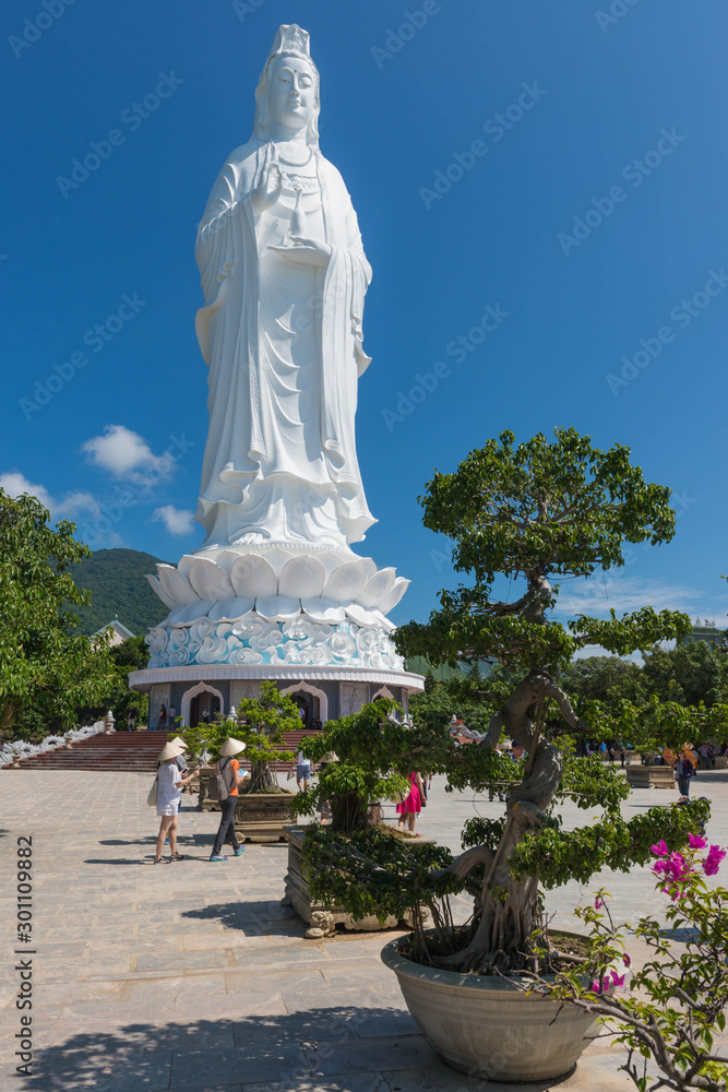 Danang Vietnam - October 24 th 2015: White Statue of Guan Yin (or Kuan Im) , the Goddess of Mercy in Taoism with sun rise in Danang Vietnam.