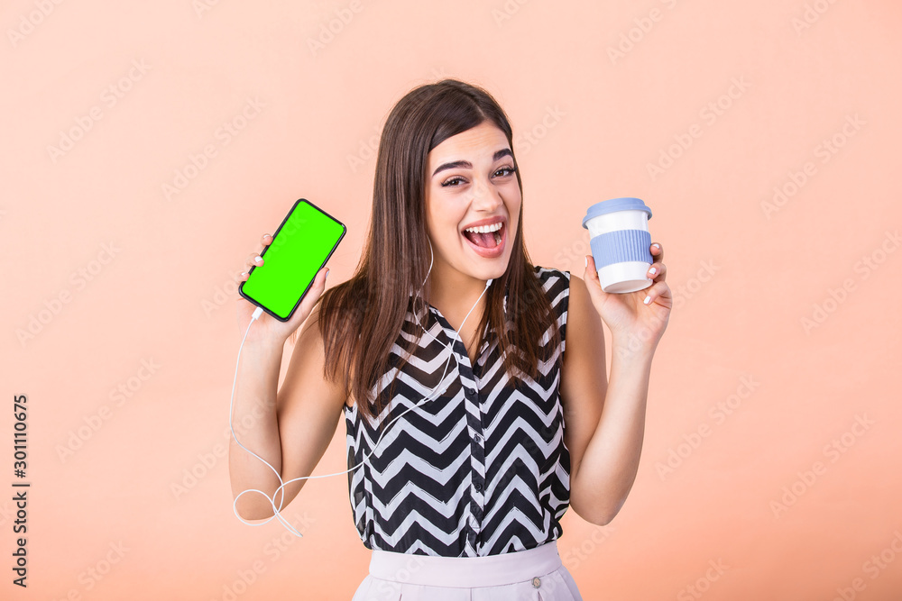 Portrait of nice attractive lovely cheerful girl holding in hands hot coffee to go cup and a mobile phone with green screen for mockup Portrait of nice attractive lovely cheerful girl holding in hands hot coffee to go cup and a mobile phone with green screen for mockup