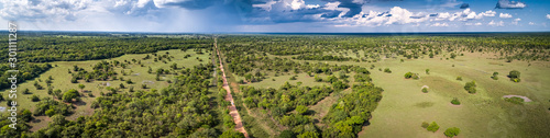 Aerial view panorama of typical Pantanal landscape with Transpantaneira, meadows, forest, pasture and dramatic sky, Pantanal Wetlands, Mato Grosso, Brazil