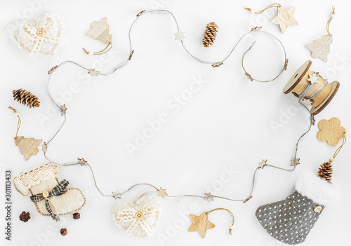 Rustic Handmade Christmas decorations from natural materials  and garland on a white background with copy space. The concept of the new year, christmas and winter holidays.Flat lay, top view. photo