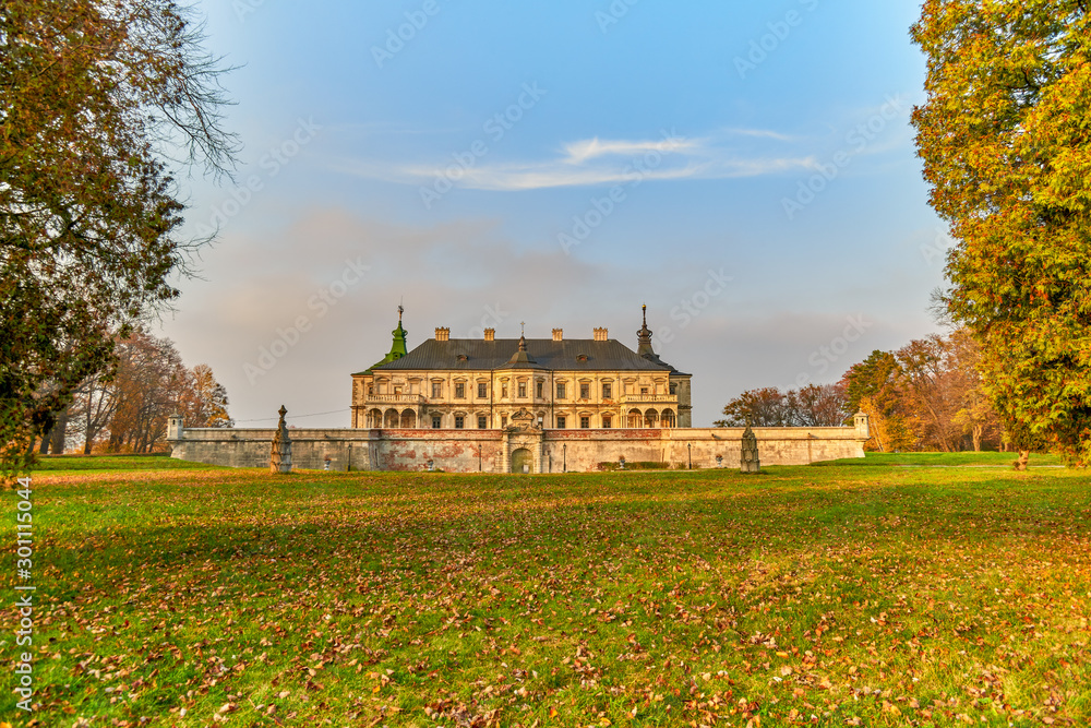 Pidhirtsi castle against fall colors and blue sky.