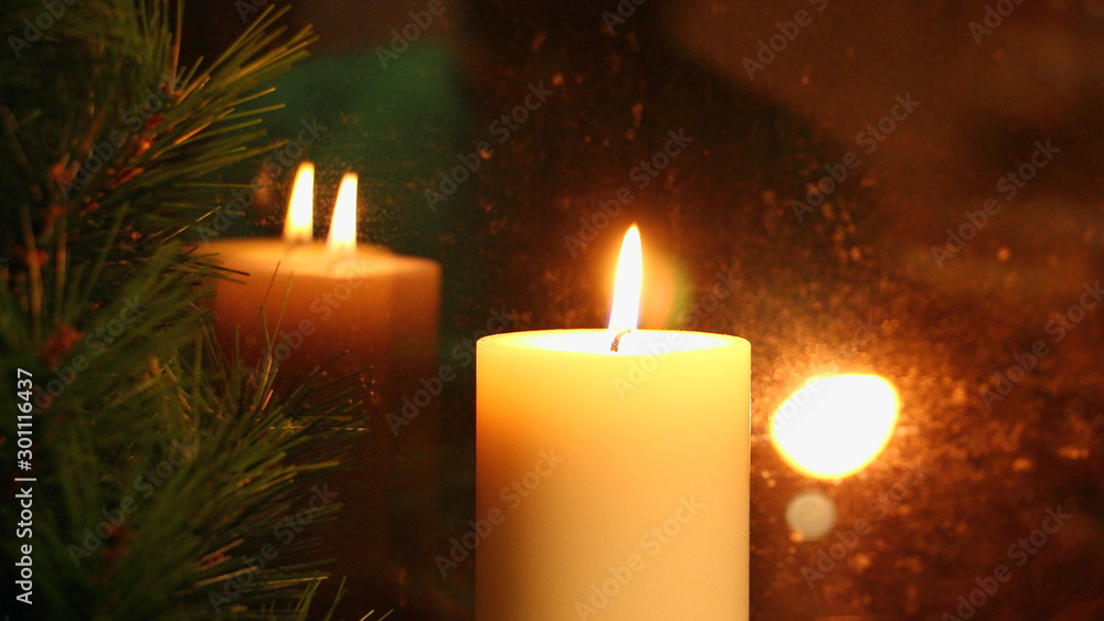 Big candle flame reflected in the glass, the Christmas holidays Big candle flame reflected in the glass, the Christmas holidays